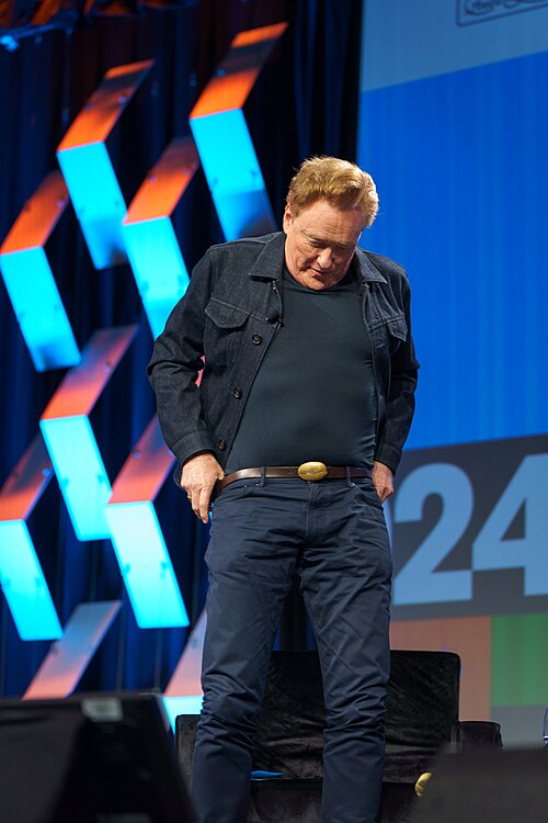 At Southwest 2024, Conan O'Brien demonstrates his disproportionately long legs