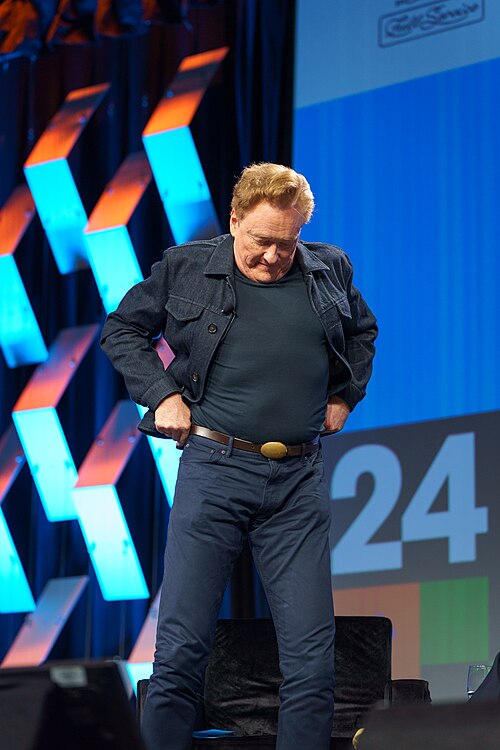 At Southwest 2024, Conan O'Brien demonstrates his disproportionately long legs