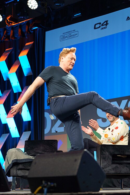 At Southwest 2024, Conan O'Brien demonstrates his disproportionately long legs