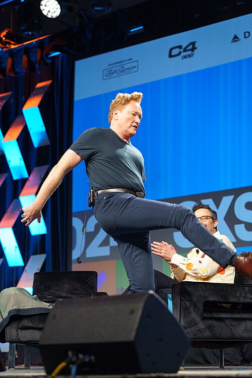 At Southwest 2024, Conan O'Brien demonstrates his disproportionately long legs