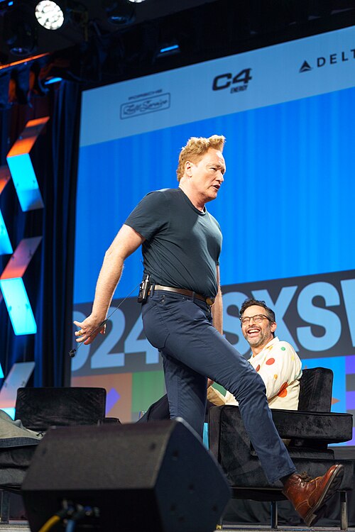 At Southwest 2024, Conan O'Brien demonstrates his disproportionately long legs