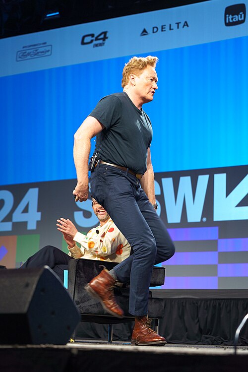 At Southwest 2024, Conan O'Brien demonstrates his disproportionately long legs