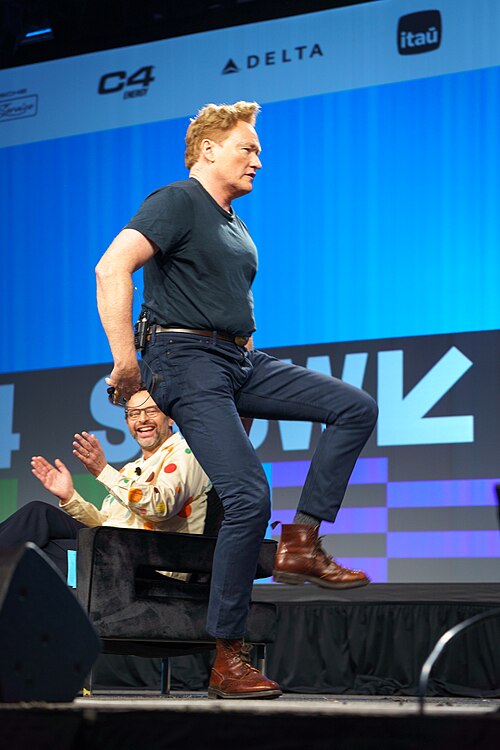 At Southwest 2024, Conan O'Brien demonstrates his disproportionately long legs