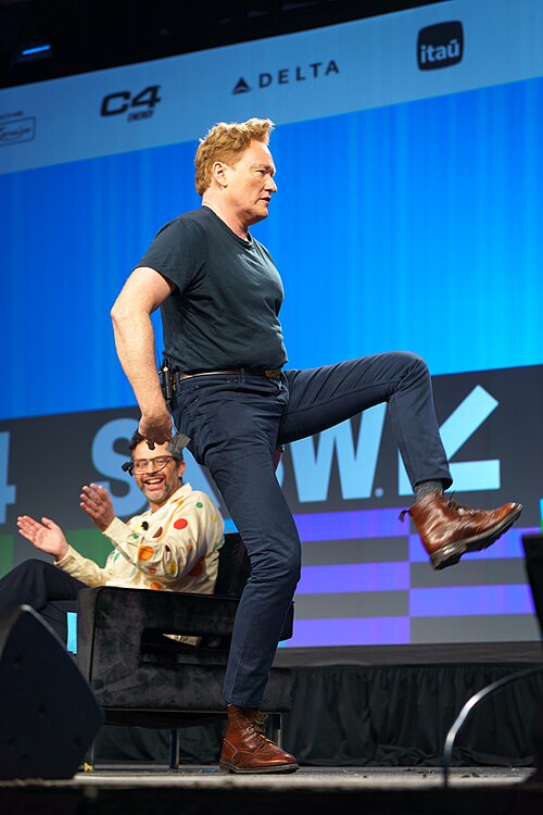 At Southwest 2024, Conan O'Brien demonstrates his disproportionately long legs