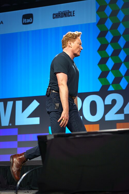 At Southwest 2024, Conan O'Brien demonstrates his disproportionately long legs