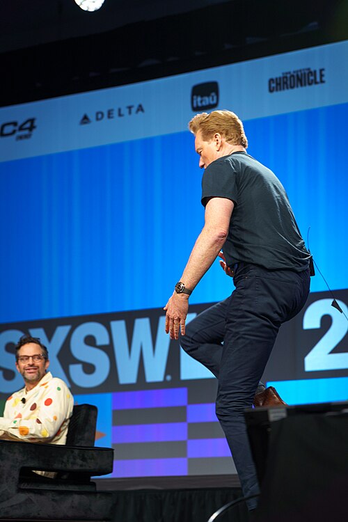 At Southwest 2024, Conan O'Brien demonstrates his disproportionately long legs
