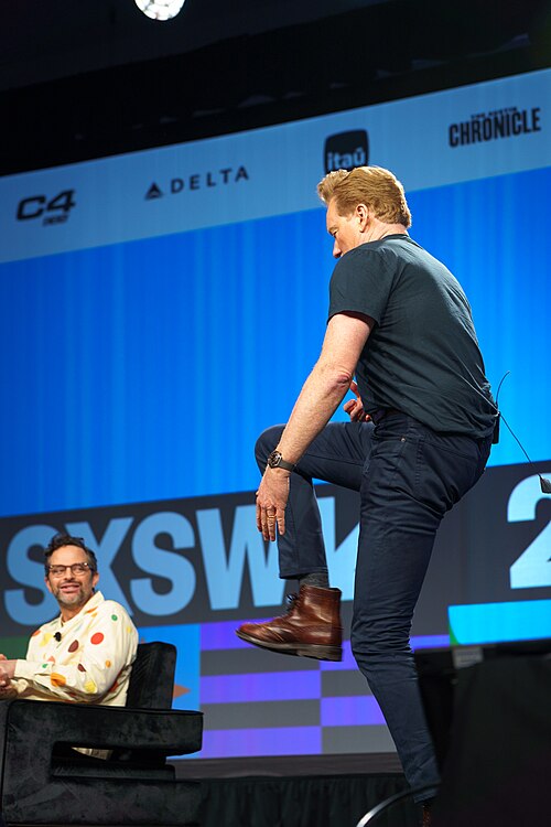 At Southwest 2024, Conan O'Brien demonstrates his disproportionately long legs