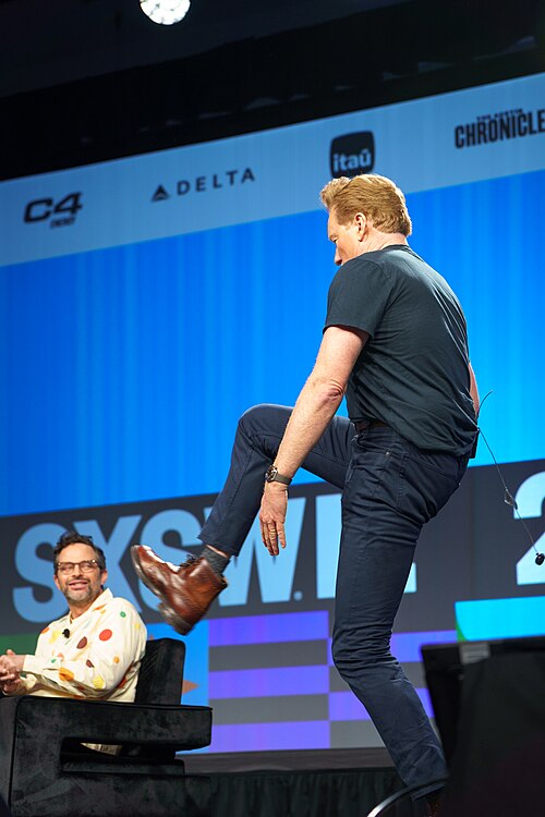At Southwest 2024, Conan O'Brien demonstrates his disproportionately long legs