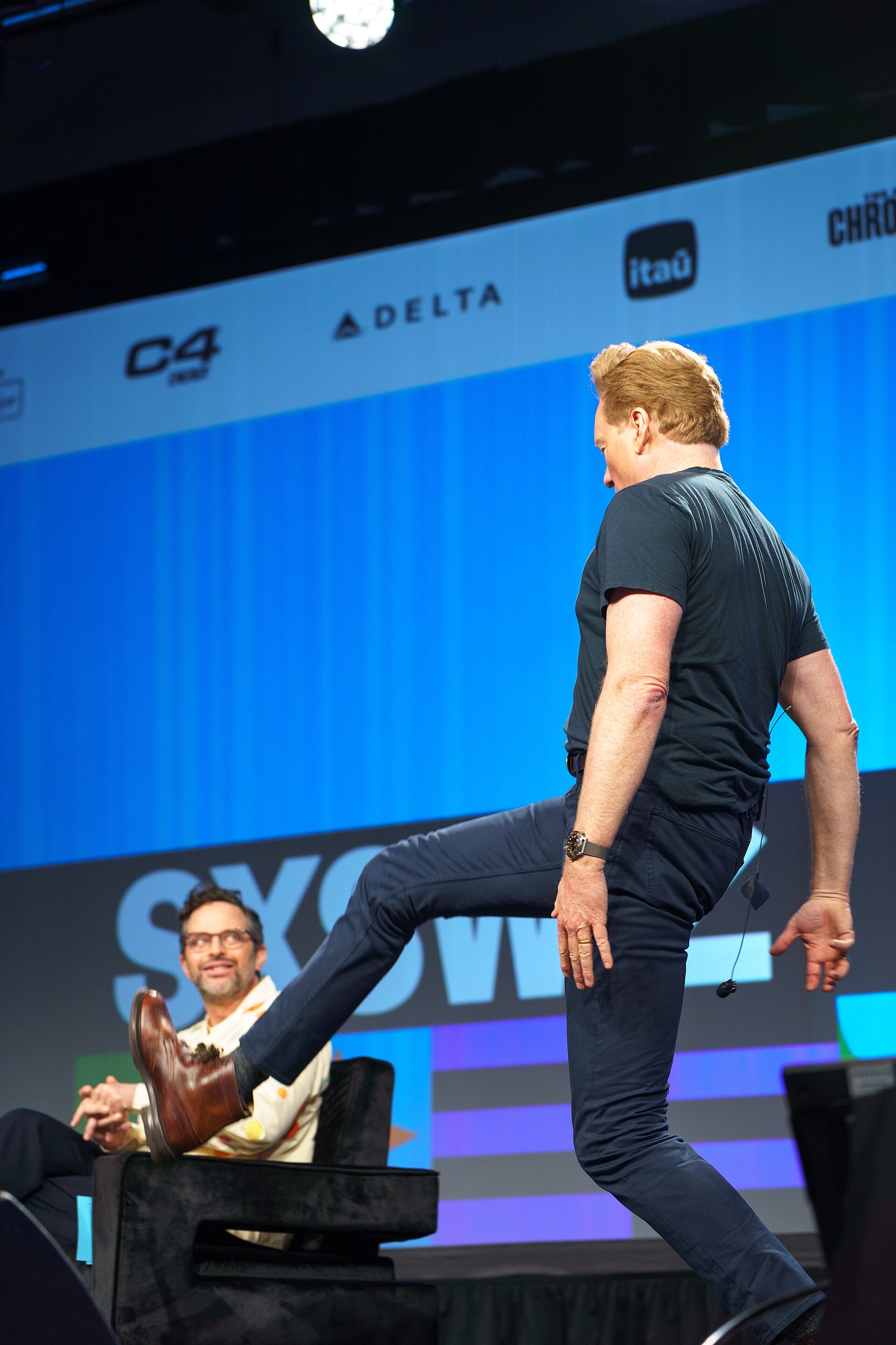 At Southwest 2024, Conan O'Brien demonstrates his disproportionately long legs