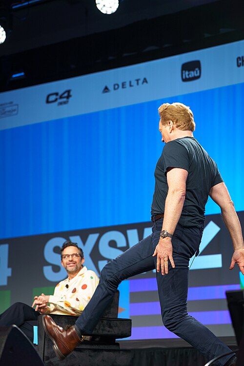 At Southwest 2024, Conan O'Brien demonstrates his disproportionately long legs