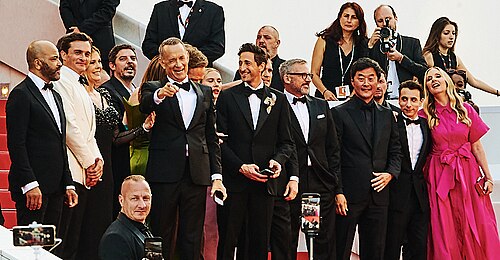 The cast of asteroid city wave to the crowd during the Cannes Film Festival in 2023