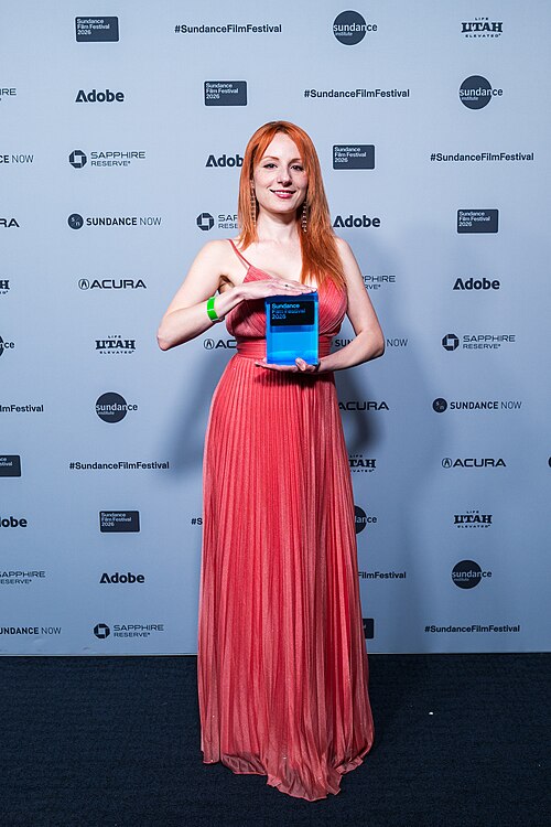 Diana Alvort at the awards ceremony at the Sundance Film Festival holding an award for "They Dream"