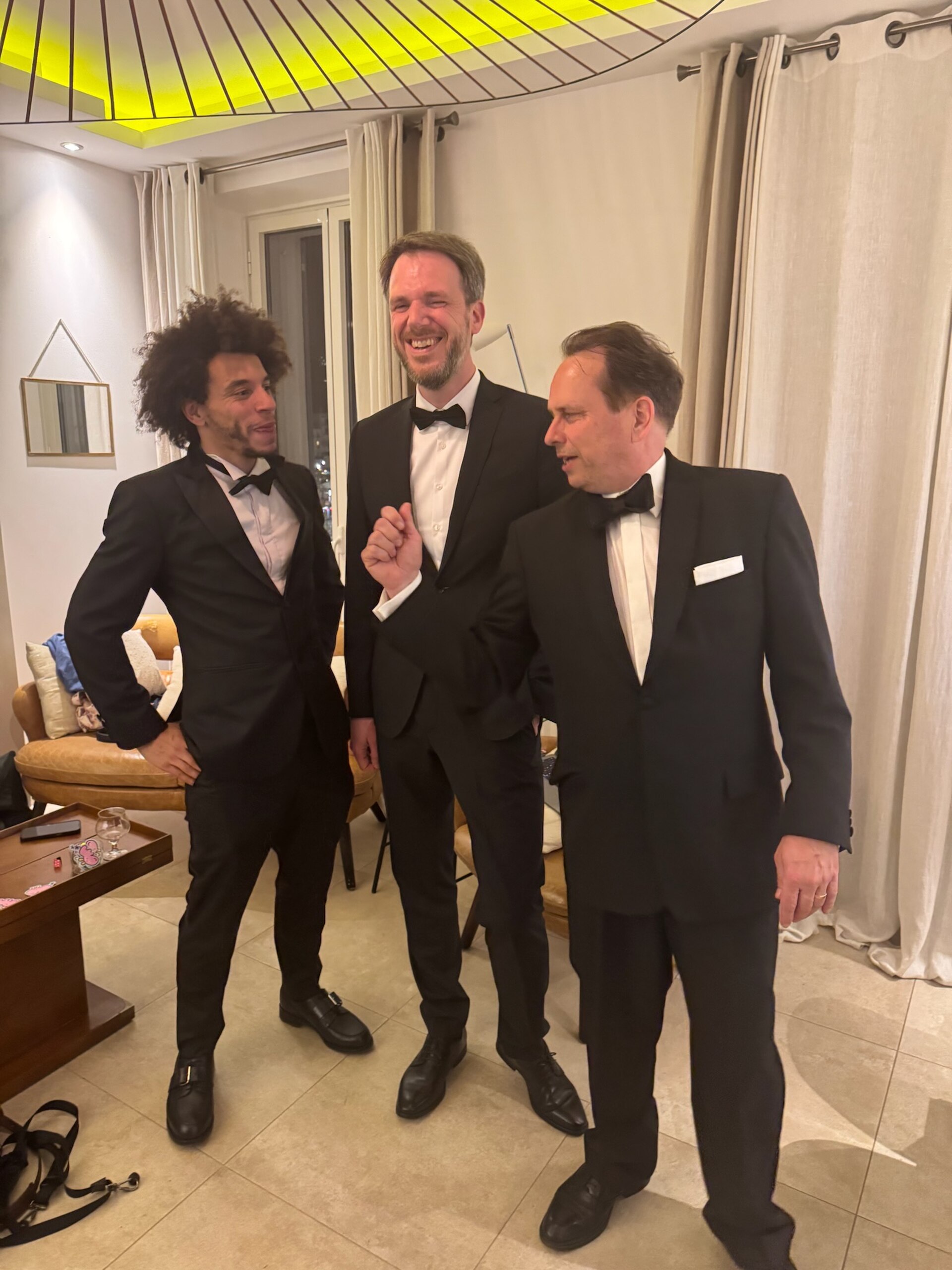 WikiPortraits photographers Gabe Hutchinson, Martin Kraft, Harald Krichel in tuxedos at Cannes Film Festival 2025