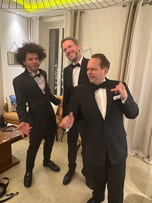 WikiPortraits photographers Gabe Hutchinson, Martin Kraft, Harald Krichel in tuxedos at Cannes Film Festival 2025