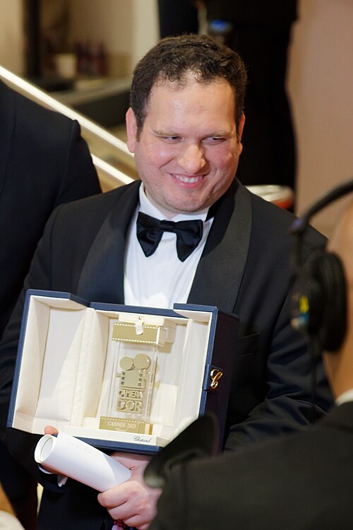 Hasan Hadi being interviewed by press after winning an award at the 2025 Cannes Film Festival.