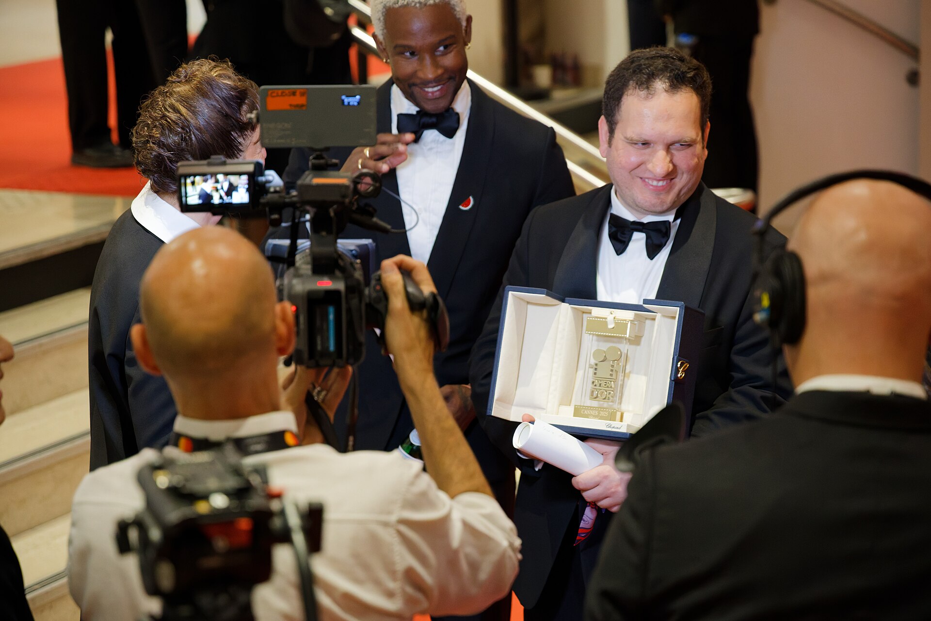 Hasan Hadi being interviewed by press after winning an award at the 2025 Cannes Film Festival.