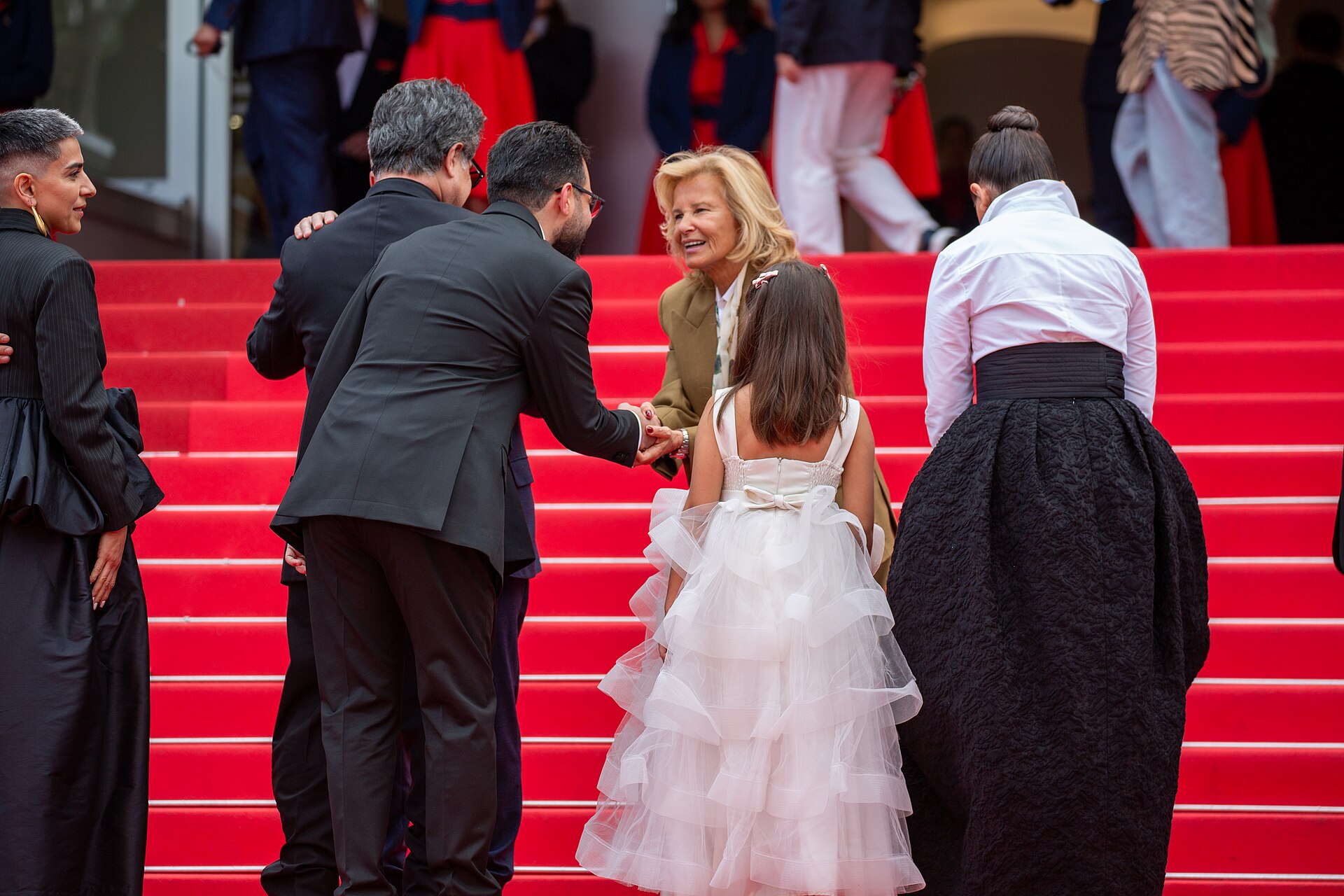 Iris Knobloch greeting cast of Un Simple Accident on Cannes Red Carpet for Premiere