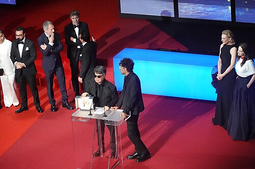 Director Jafar Panahi accepting Palme d'Or for Un Simple Accident at Cannes 2025