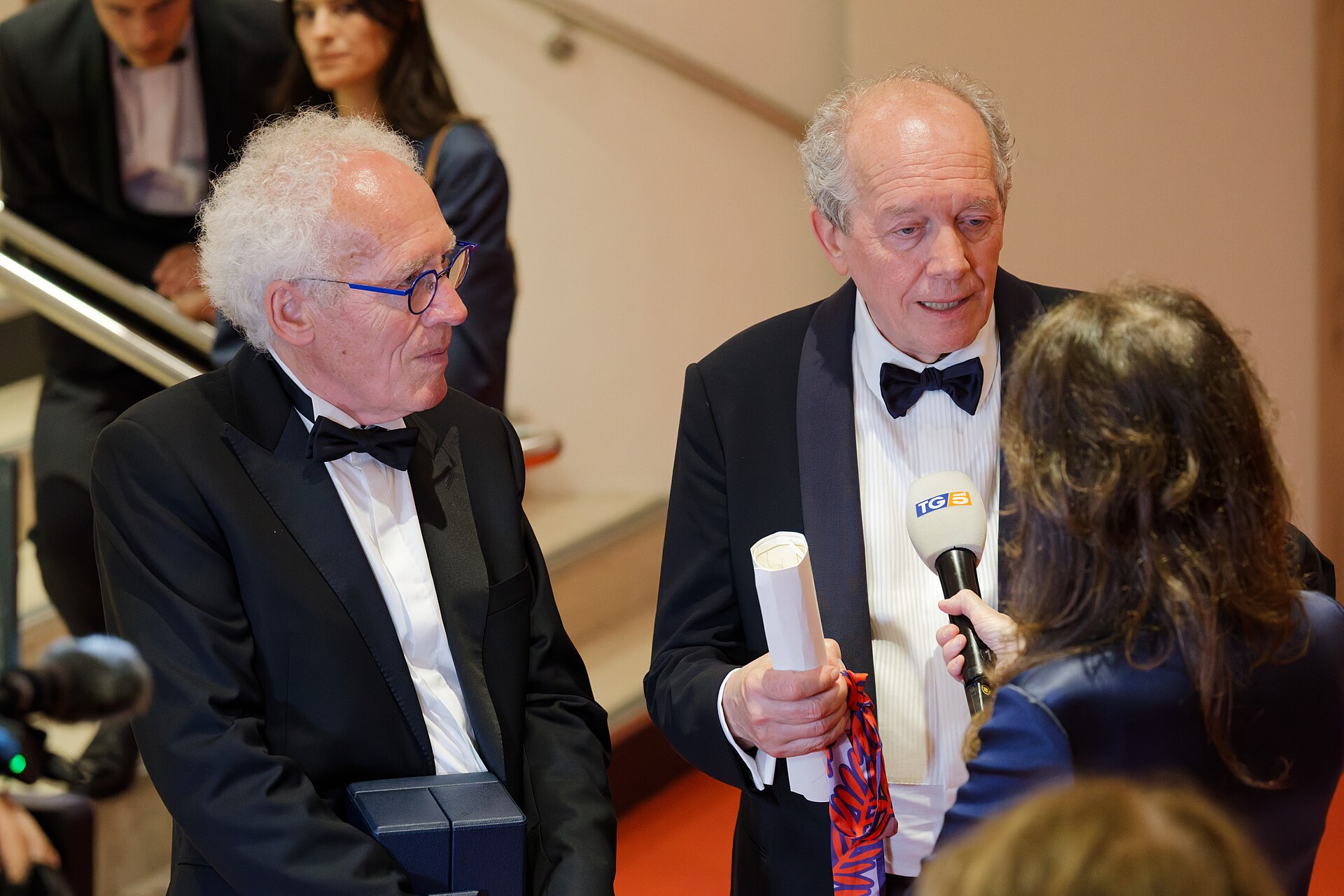 Jean-Pierre Dardenne and Luc Dardenne being interviewed by press after winning an award at the 2025 Cannes Film Festival.
