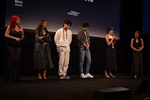 Jiayi Li, Ira Hetaraka, Kevin Jin Kwan Kim, Frank Sun, Chelsie Pennello, and Olivia Owyeung at a 2025 Tribeca Film Festival red carpet in New York City for the film Floating Roots Shorts Program.
