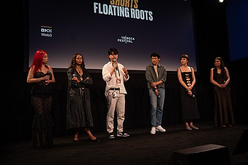 Jiayi Li, Ira Hetaraka, Kevin Jin Kwan Kim, Frank Sun, Chelsie Pennello, and Olivia Owyeung at a 2025 Tribeca Film Festival red carpet in New York City for the film Floating Roots Shorts Program.