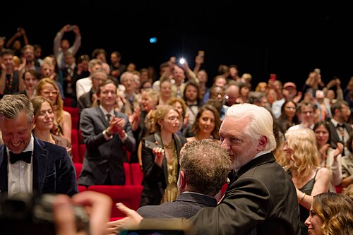Julian Assange and Eugene Jarecki in the audience after the premiere of The Six Billion Dollar Man at the 2025 Cannes Film Festival