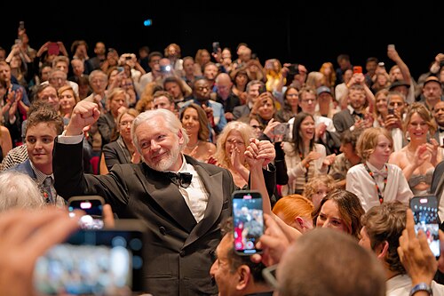 Julian Assange in the audience after the premiere of The Six Billion Dollar Man at the 2025 Cannes Film Festival
