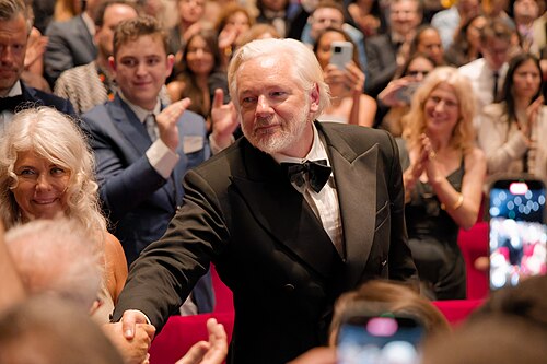 Julian Assange in the audience after the premiere of The Six Billion Dollar Man at the 2025 Cannes Film Festival