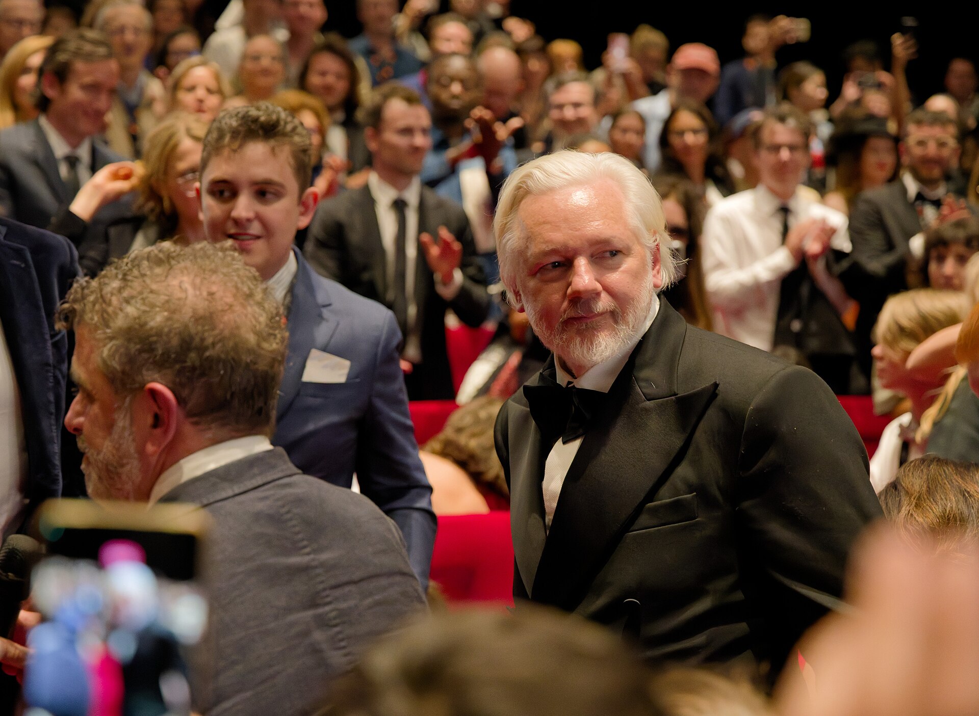 Julian Assange in the audience after the premiere of The Six Billion Dollar Man at the 2025 Cannes Film Festival