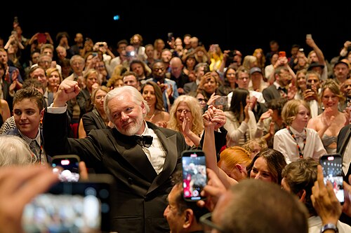 Julian Assange in the audience after the premiere of The Six Billion Dollar Man at the 2025 Cannes Film Festival