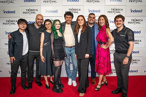 Kenny Ridwan, Scott Aharoni, Starr Jiang, Jade Spear, Frank Sun, Dina Graham, Alex Constantin, Yvonne Chen, and Logan K Triplett at a 2025 Tribeca Film Festival red carpet in New York City for the film We Are Kings.
