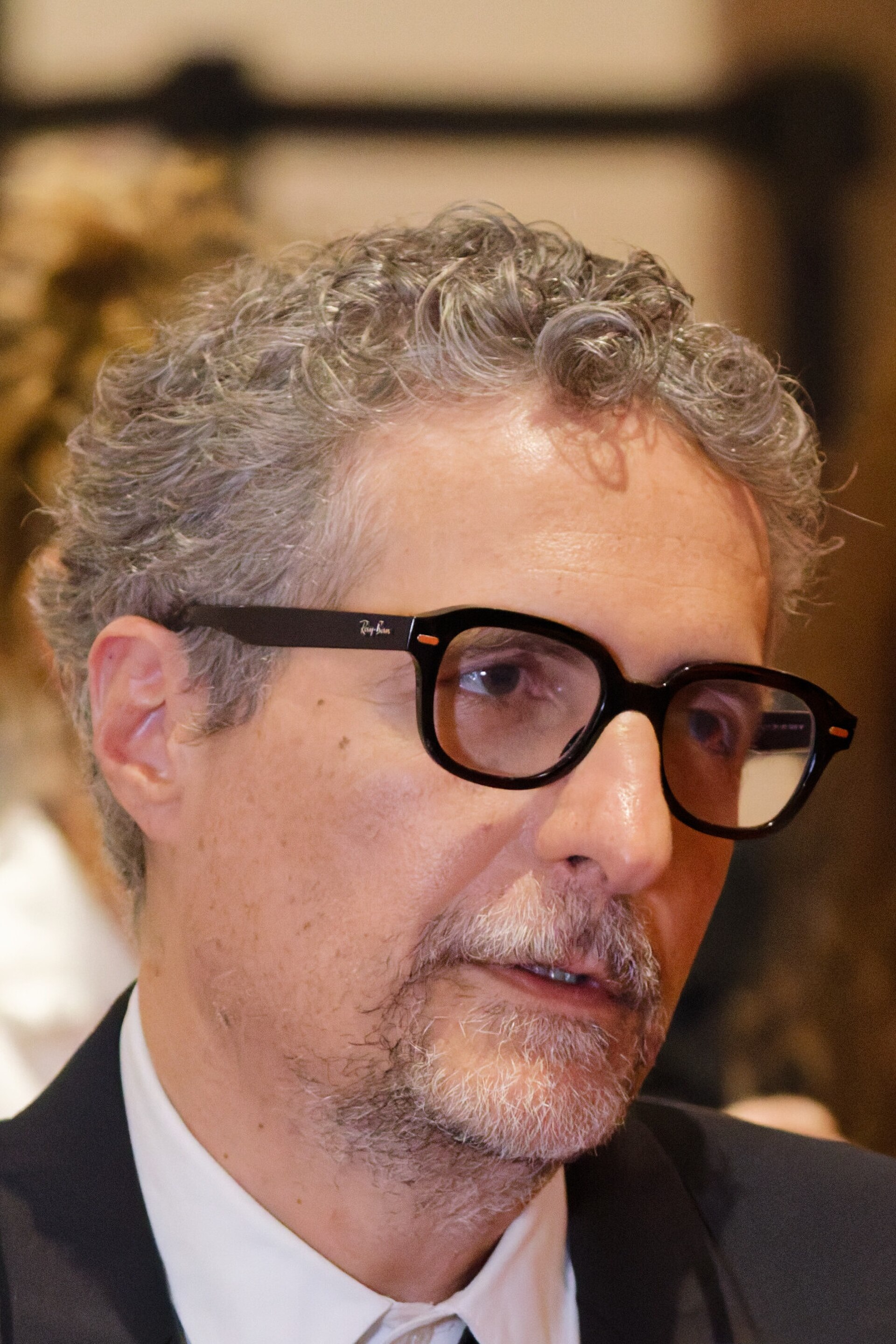 Kleber Mendonça Filho being interviewed by press after winning an award at the 2025 Cannes Film Festival.