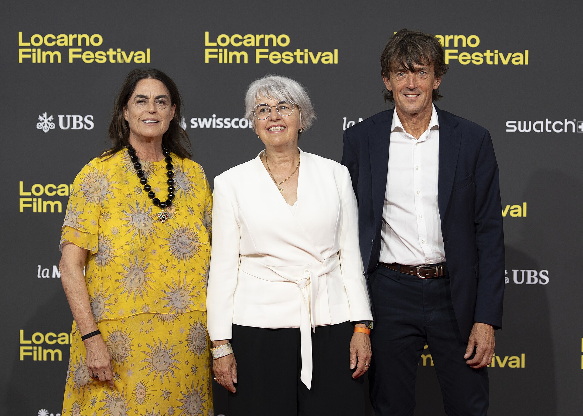 President Maja Hoffmann, Swiss Minister Elisabeth Baume-Schneider and husband Pierre-André Baume at the 78th Locarno Film Festival red carpet