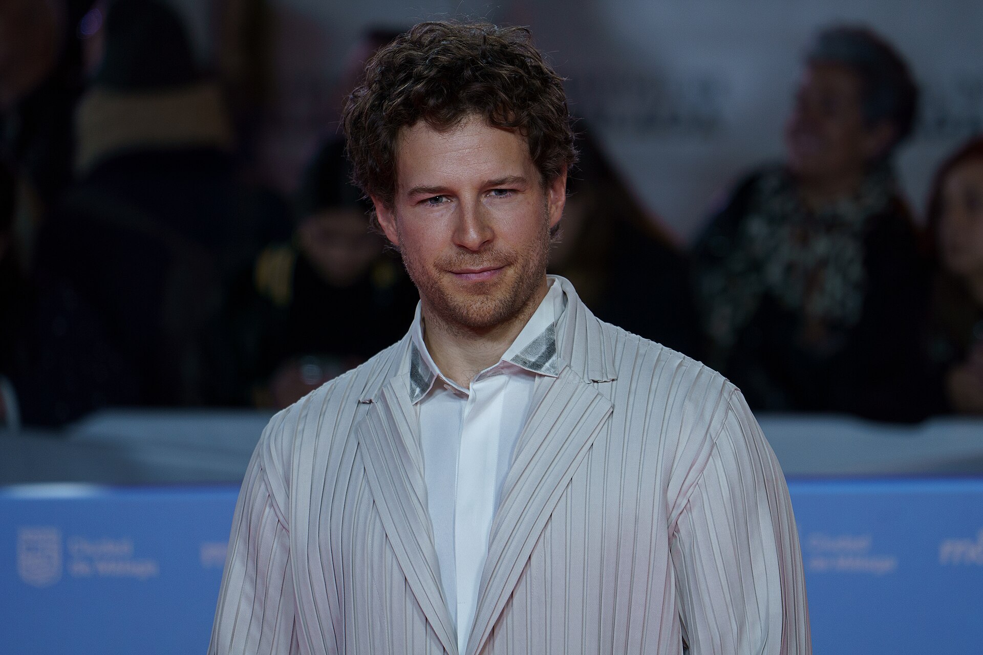 Álvaro Cervantes at the Red Carpet of the Malaga 2025 Festival next to Cervantes Theater