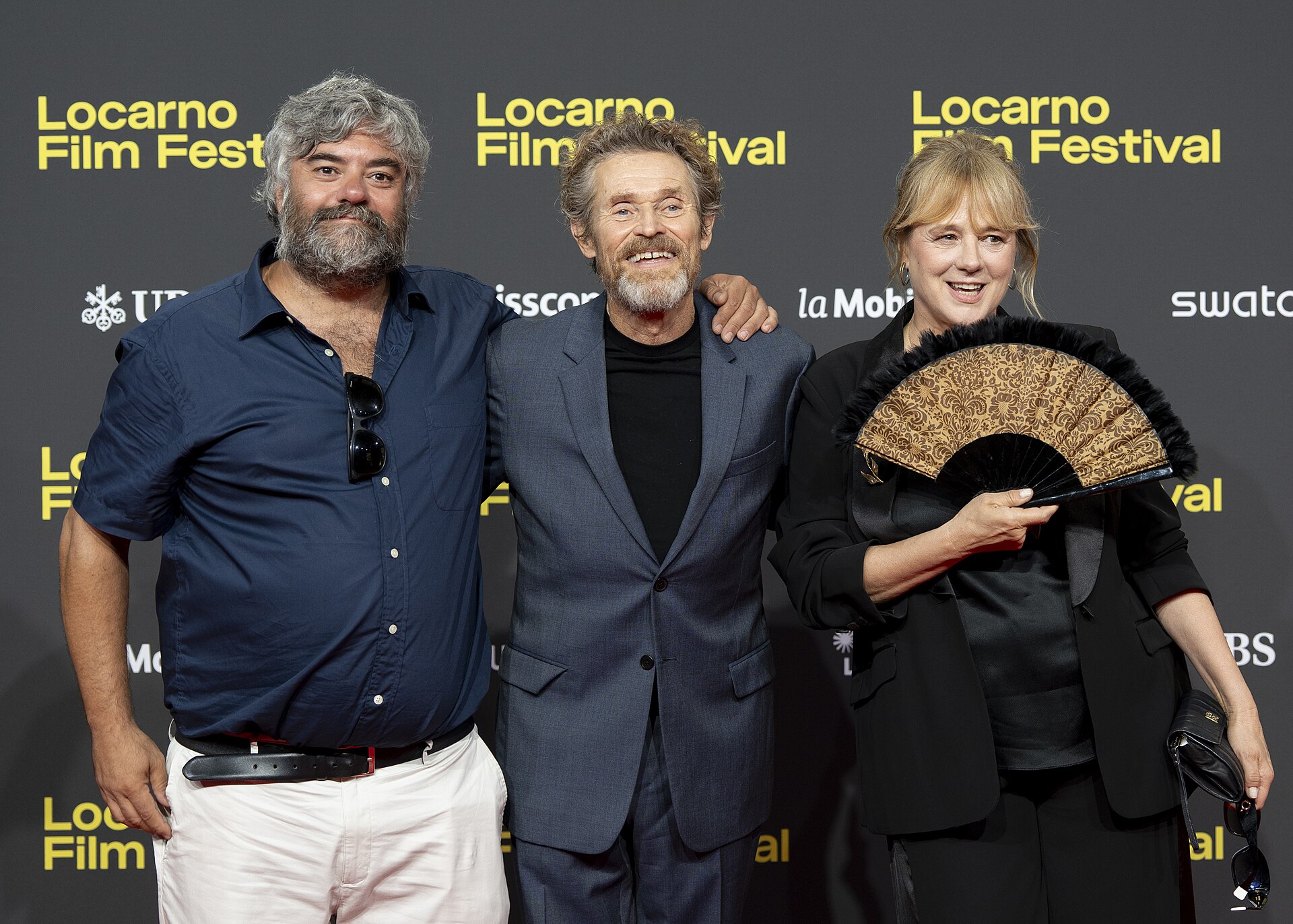 Director Miguel Ángel Jiménez, actor Willem Dafoe and actress Emma Suárez at 78th Locarno Film Festival red carpet for The Birthday Party