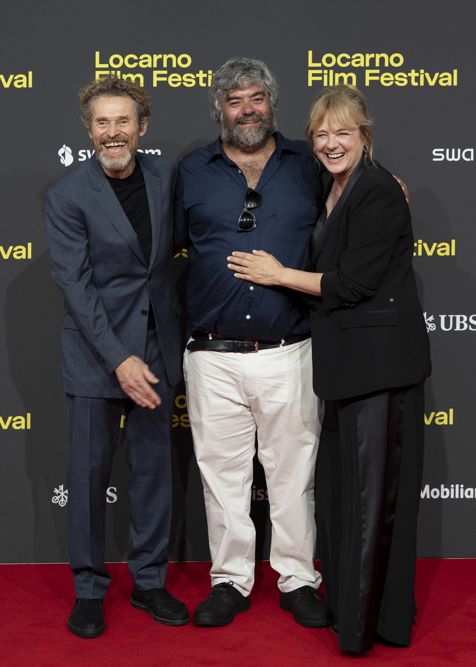 Director Miguel Ángel Jiménez, actor Willem Dafoe and actress Emma Suárez at 78th Locarno Film Festival red carpet for The Birthday Party