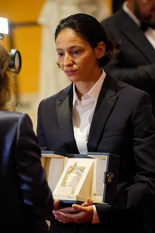 Nadia Melliti being interviewed by press after winning an award at the 2025 Cannes Film Festival.