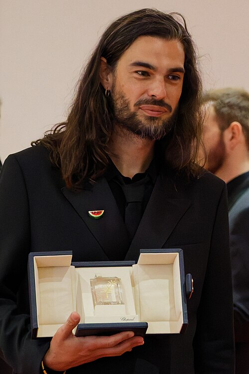 Oliver Laxe being interviewed by press after winning an award at the 2025 Cannes Film Festival.