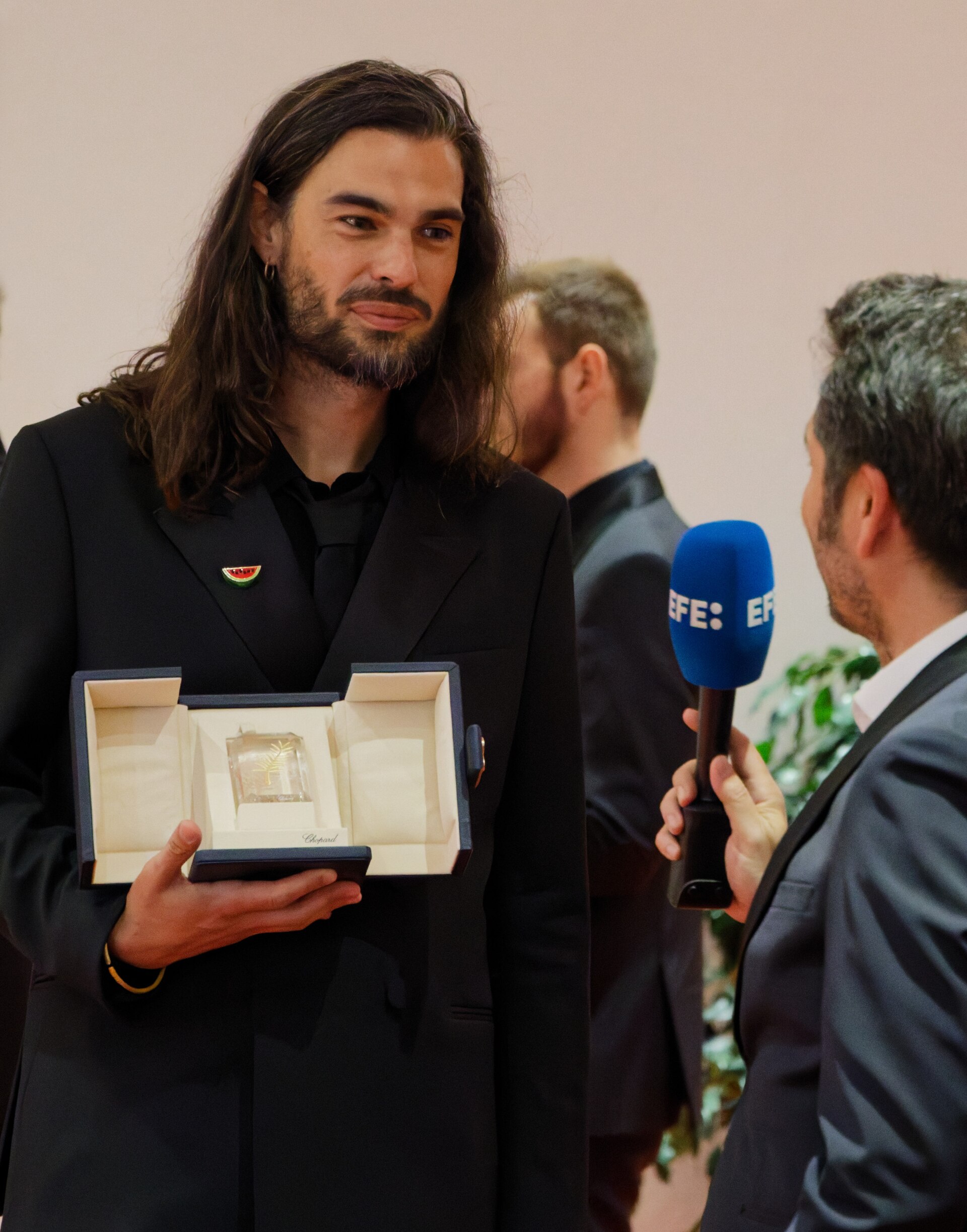 Oliver Laxe being interviewed by press after winning an award at the 2025 Cannes Film Festival.