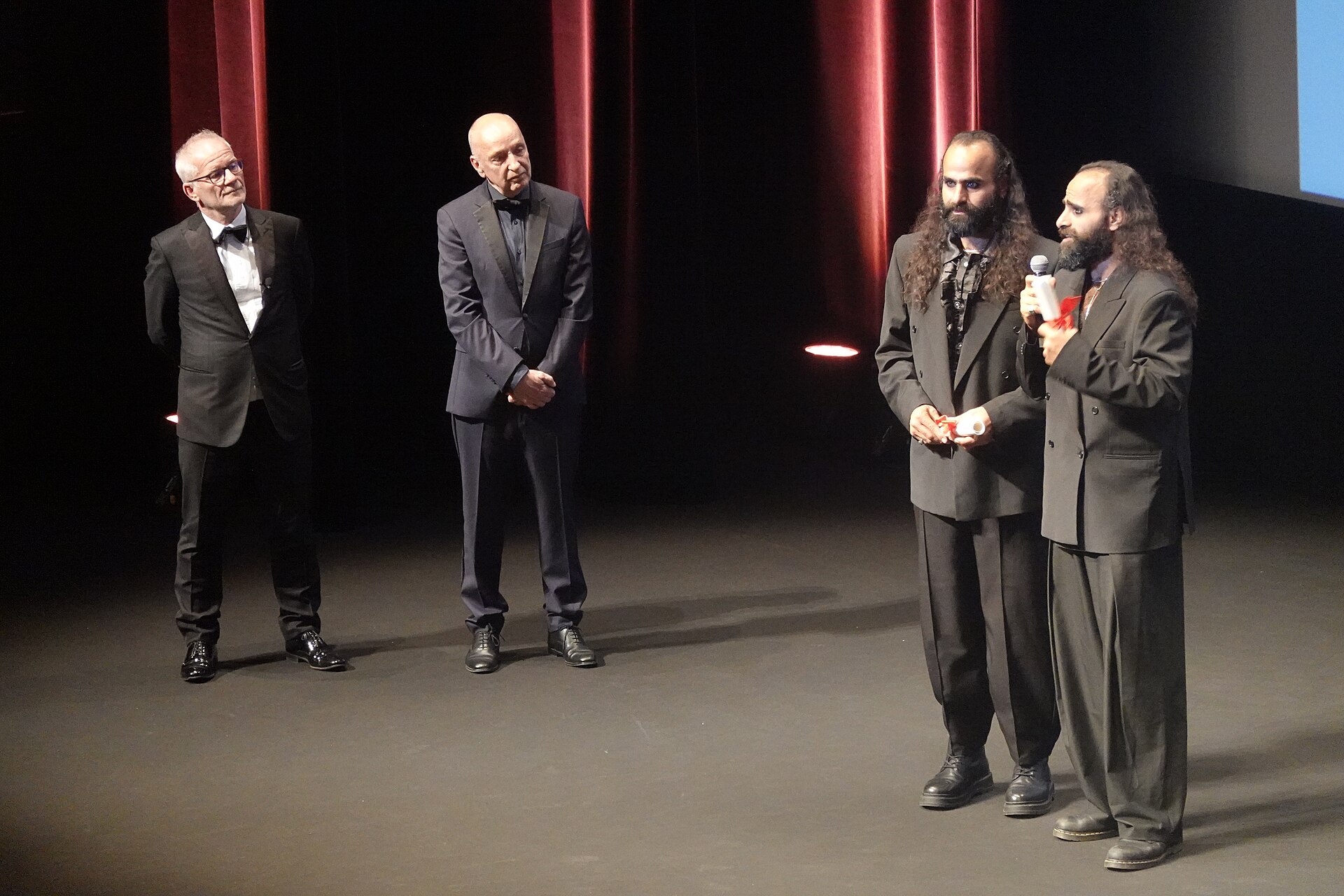 Tarzan Nasser and Arab Nasser, Palestinian film directors, accepting the Un Certain Regard directing award for Once Upon a Time in Gaza at 2025 Cannes Film Festival