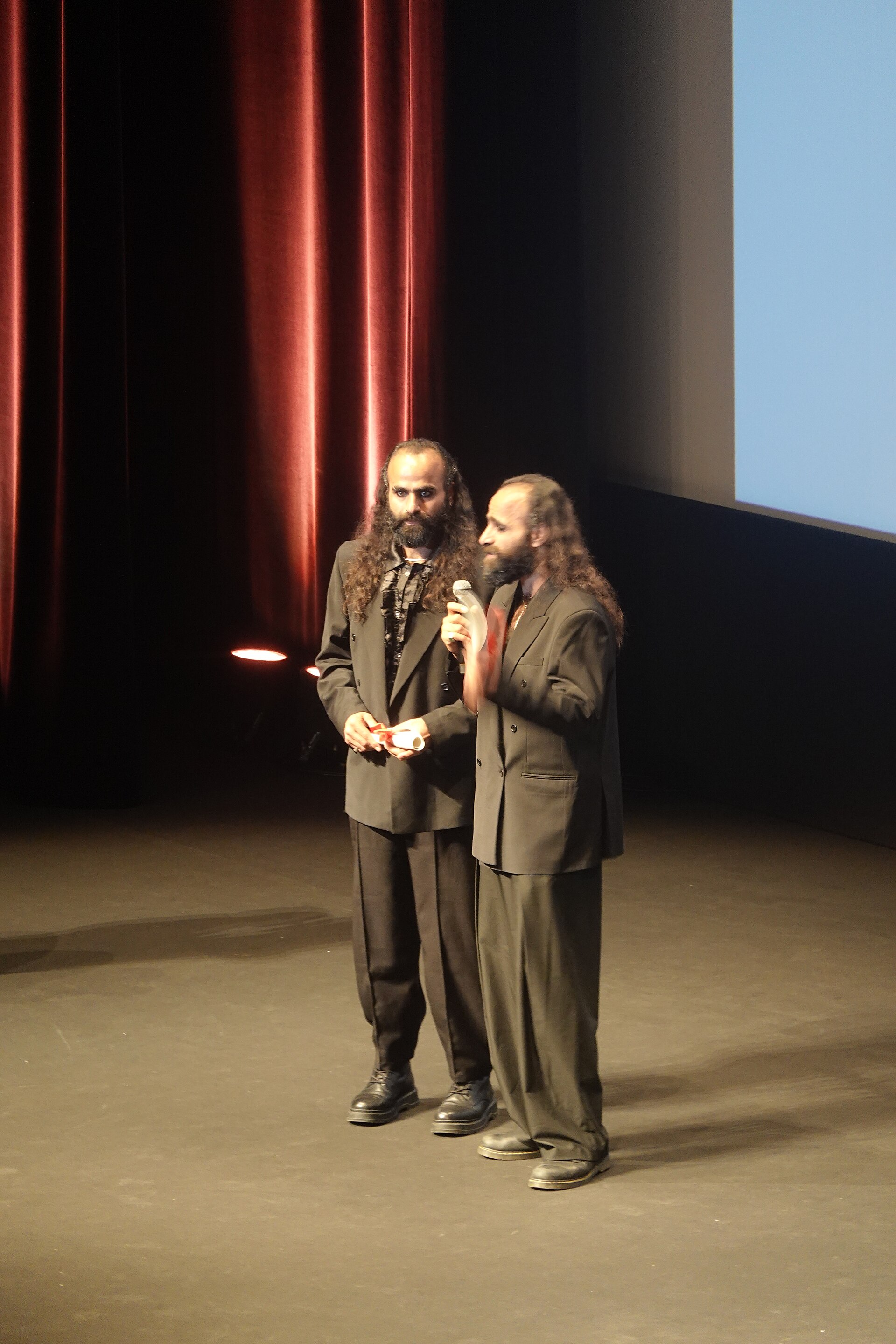 Tarzan Nasser and Arab Nasser, Palestinian film directors, accepting the Un Certain Regard directing award for Once Upon a Time in Gaza at 2025 Cannes Film Festival