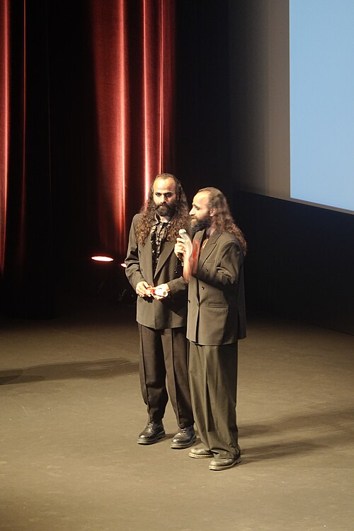 Tarzan Nasser and Arab Nasser, Palestinian film directors, accepting the Un Certain Regard directing award for Once Upon a Time in Gaza at 2025 Cannes Film Festival