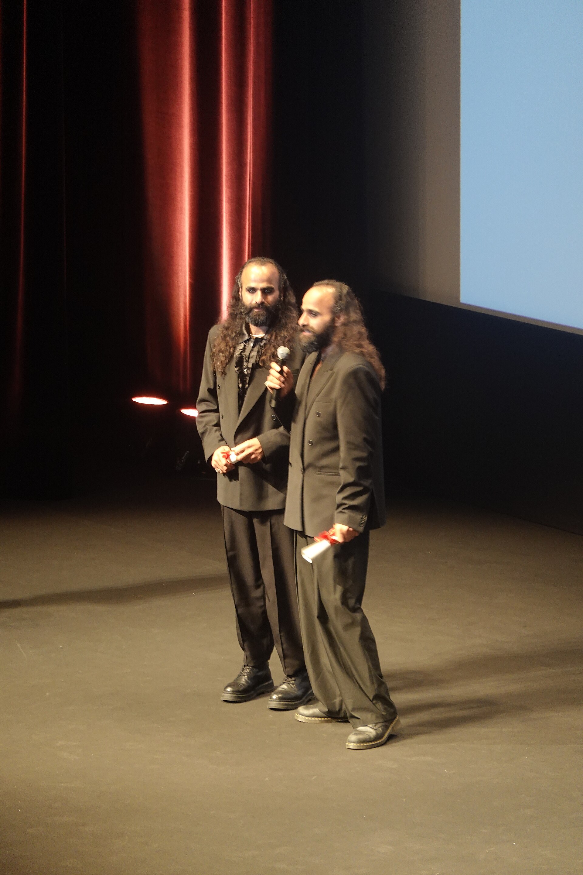 Tarzan Nasser and Arab Nasser, Palestinian film directors, accepting the Un Certain Regard directing award for Once Upon a Time in Gaza at 2025 Cannes Film Festival