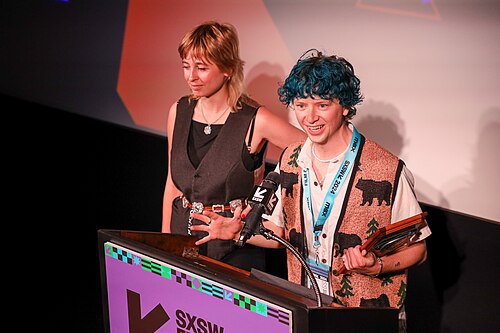 Eros Vlahos (Eros V) on stage at the SXSW 2024 Film Festival award ceremony that took place at the Paramount Theatre in Austin, Texas. Vlahos won the SXSW 2024 Midnight Shorts Competition Special Jury Award for the film Meat Puppet.
