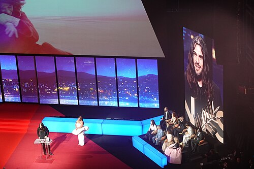 Director Oliver Laxe accepting a shared Jury Award at Cannes 2025 for Sirât