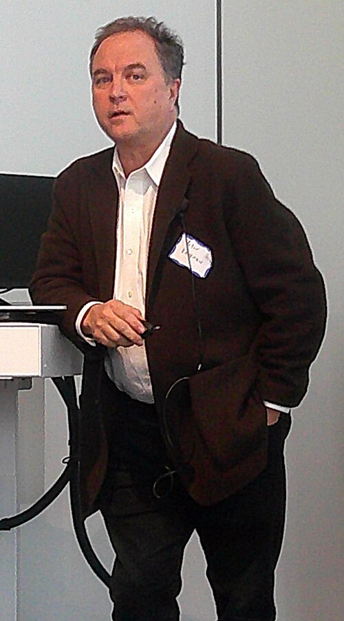 Photograph of American writer and teacher Peter B. Kaufman at the Wikipedia 25 event at MIT.  He is speaking at a panel discussion.