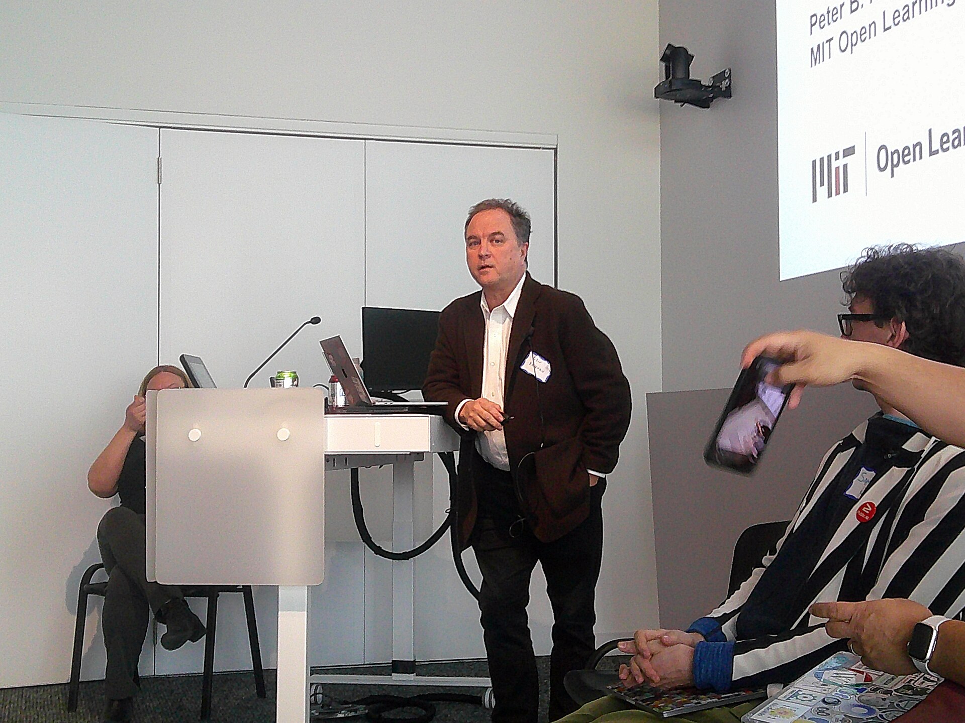Photograph of American writer and teacher Peter B. Kaufman at the Wikipedia 25 event at MIT.  He is speaking at a panel discussion.