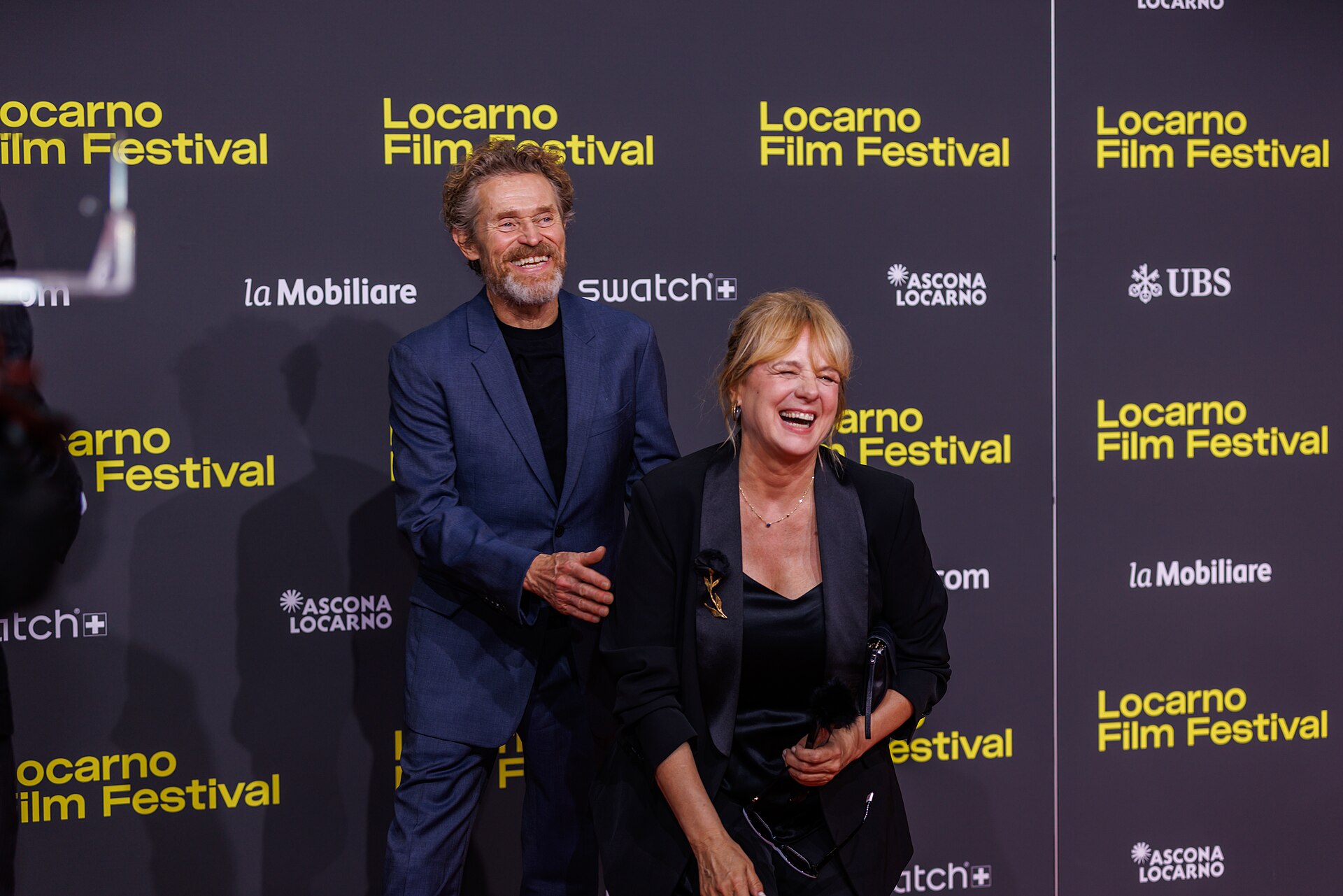 Willem Dafoe and Emma Suarez attend the 'The Birthday Party' red carpet during the 78th Locarno Film Festival on August 07, 2025 in Locarno, Switzerland.