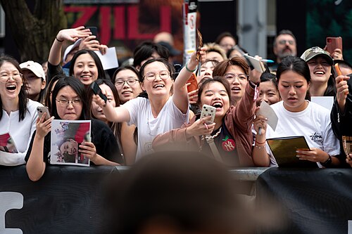 Fans of Peter Ho-sun Chan call for security to close King Street to allow him to greet his fans. At the screening of The Road Not Taken at the 2026 Toronto International Film Festival.