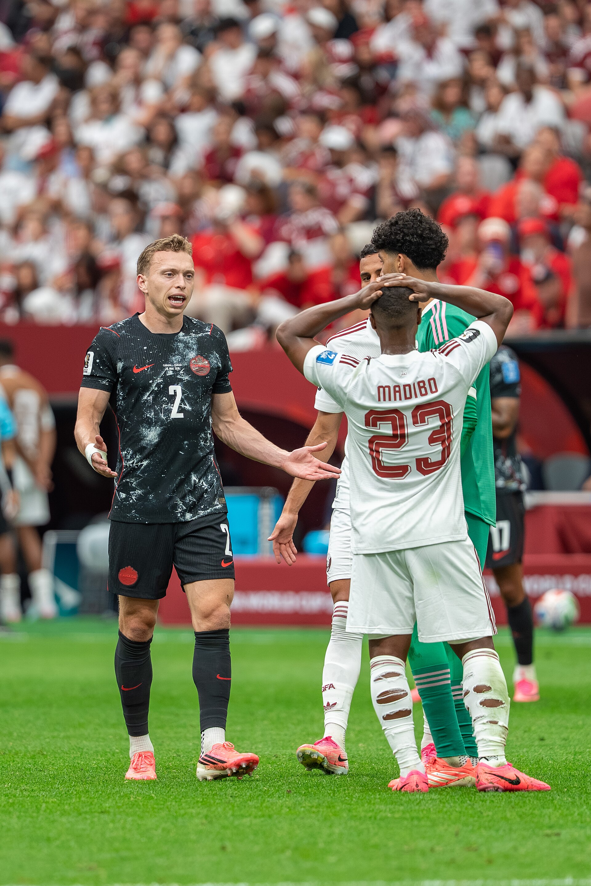 Alistair Johnston Assim Madibo during Canada v Qatar on 18 June 2026 at the 2026 FIFA World Cup
